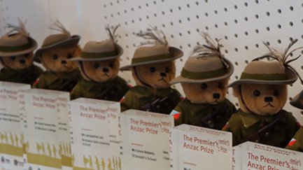Teddy bears wearing ANZAC uniforms and lined up.